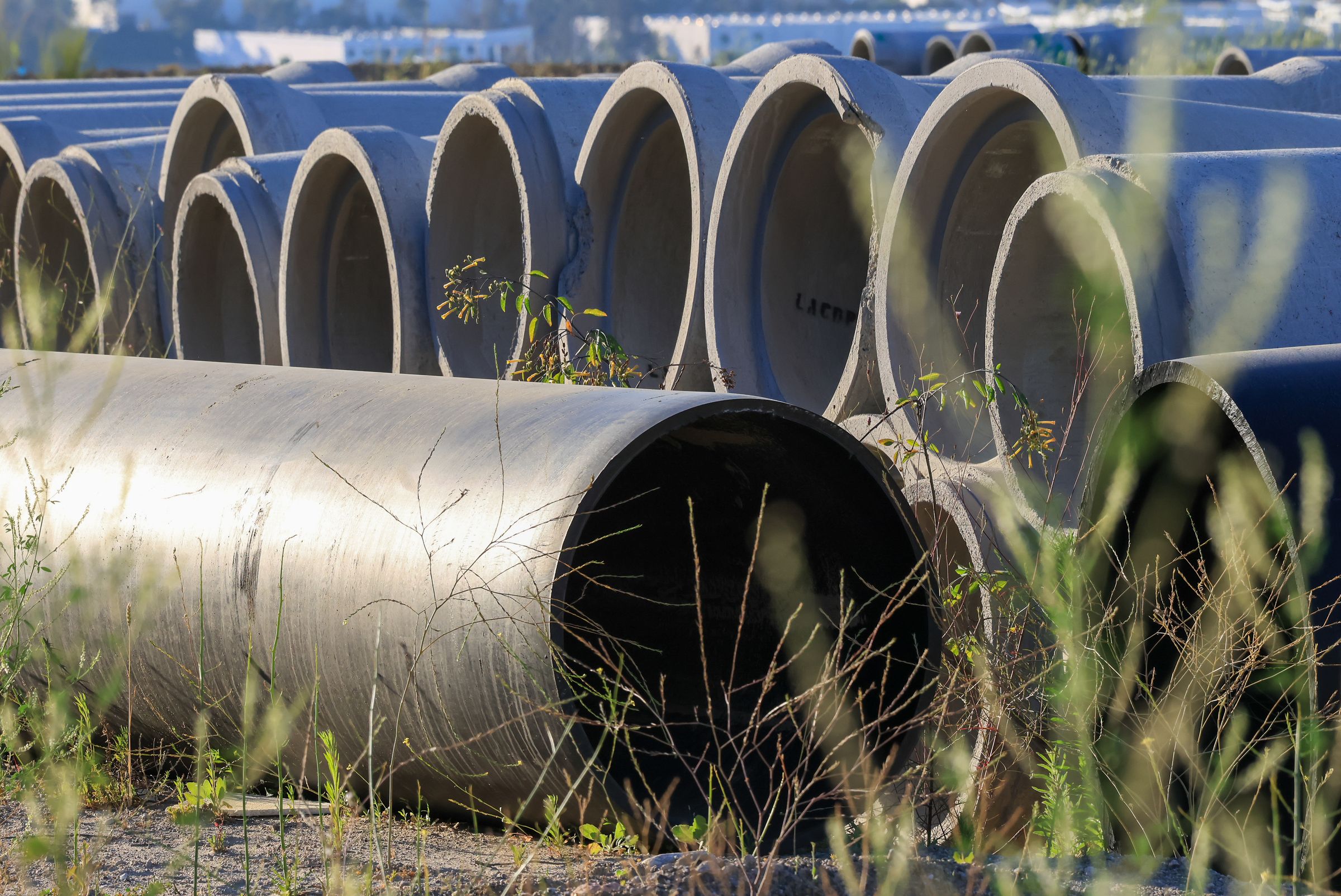 Stacked concrete pipes at an outdoor storage yard